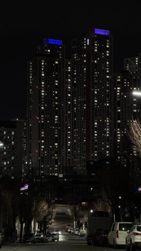 Apartment towers at night, a few windows lit